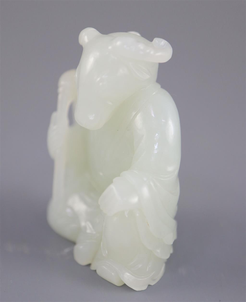 A Chinese pale celadon jade seated figure of a ram-headed immortal, 4.9cm high